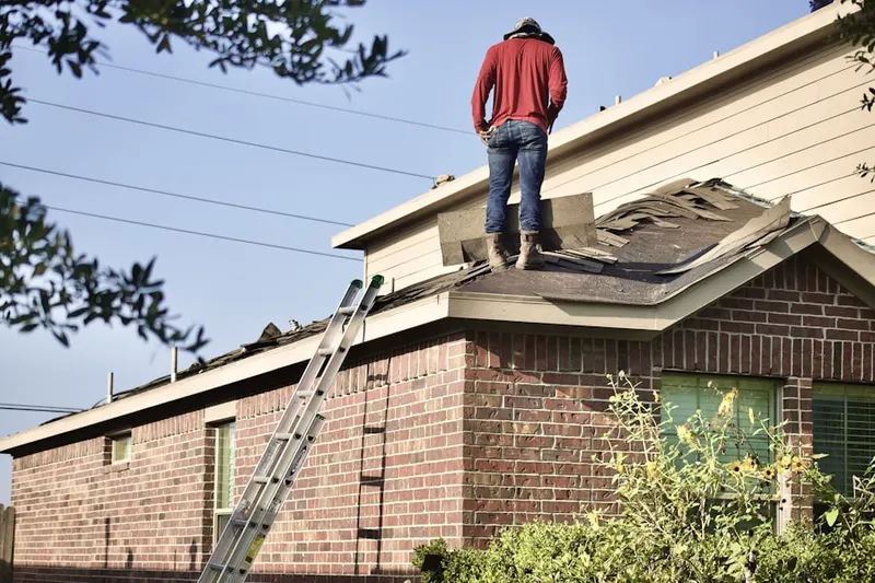 Professional roofer working on a residential roof in Blooming Grove